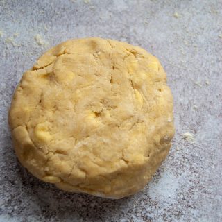 Pie dough on a grey background.