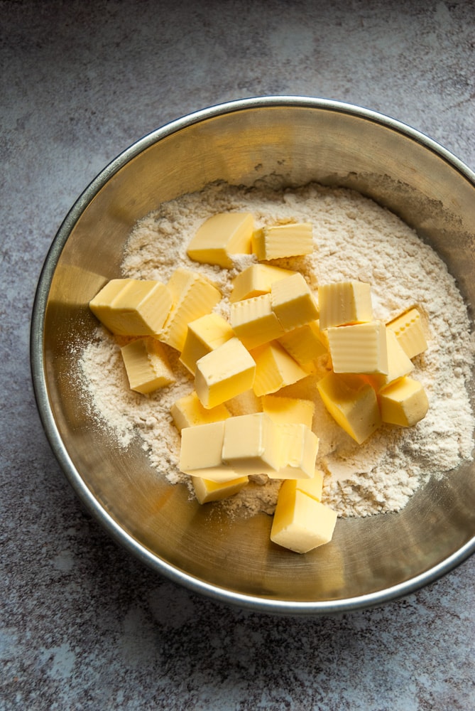 a bowl of cubed butter and flour.