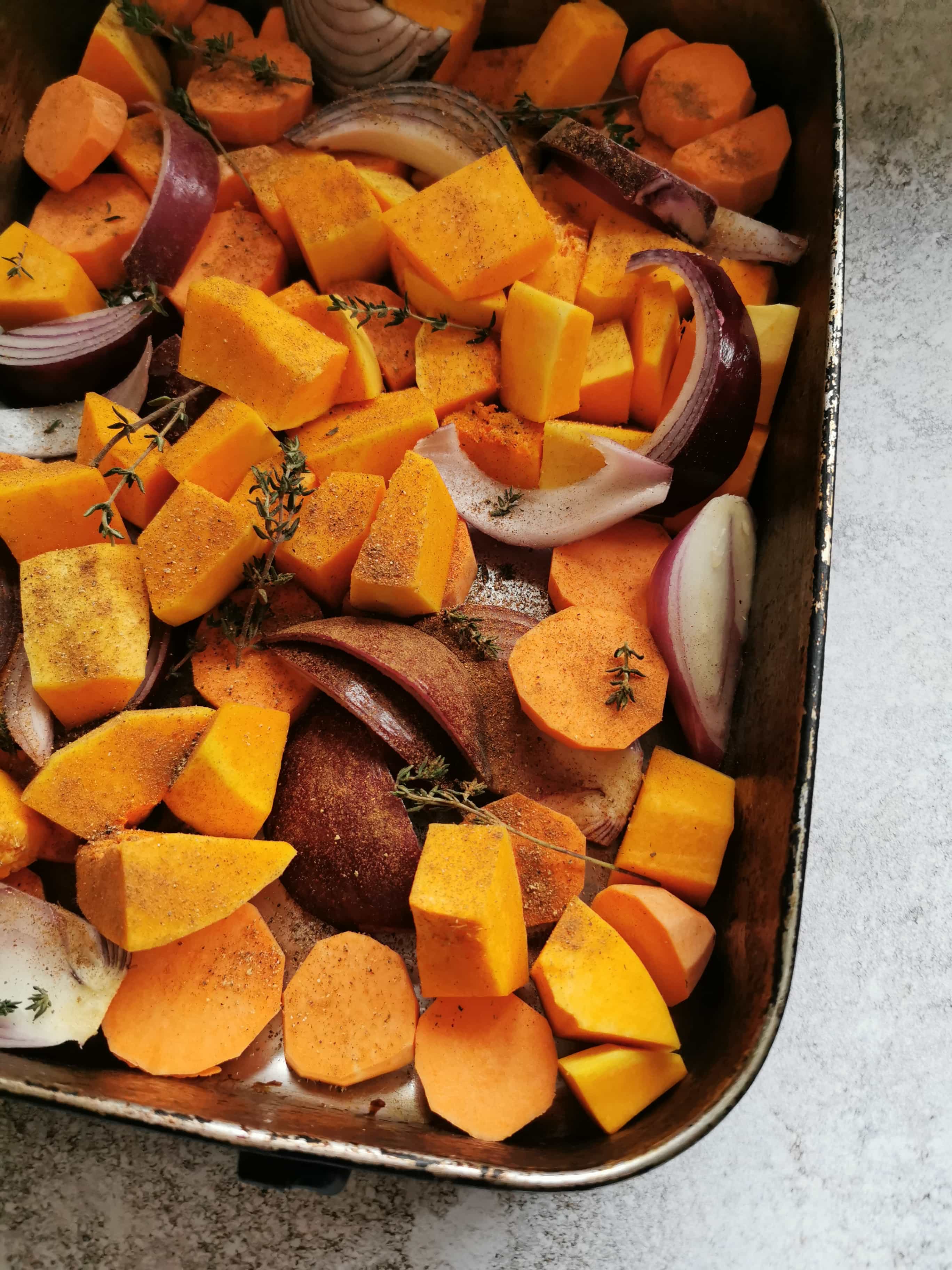 A tray of roasted butternut squash, sweet potato and red onion.