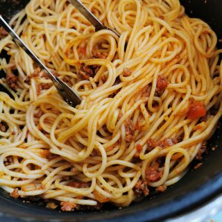 a pan of spaghetti and bolognese sauce