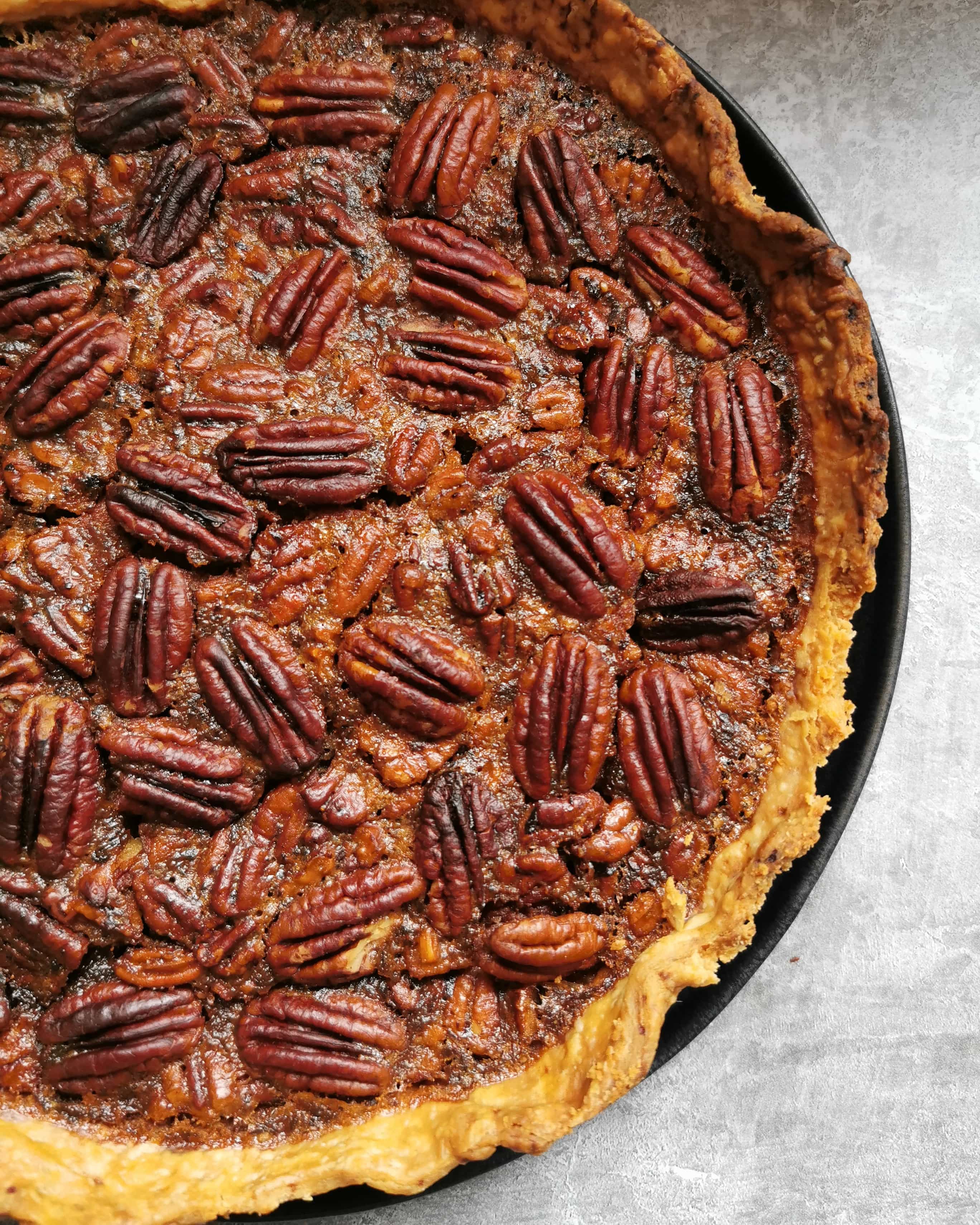 A close up picture of a classic Pecan pie. 