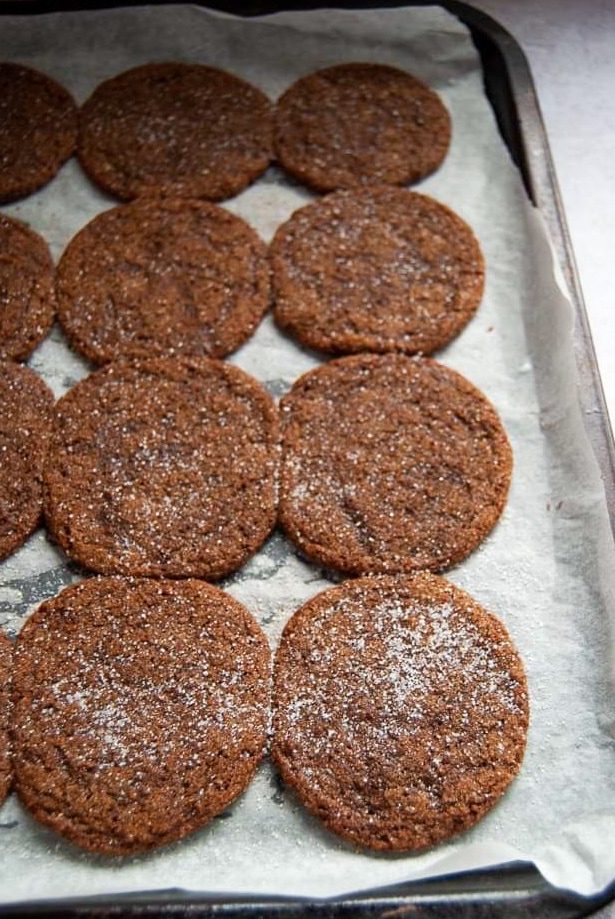 A tray of freshly baked ginger cookies on a baking tray