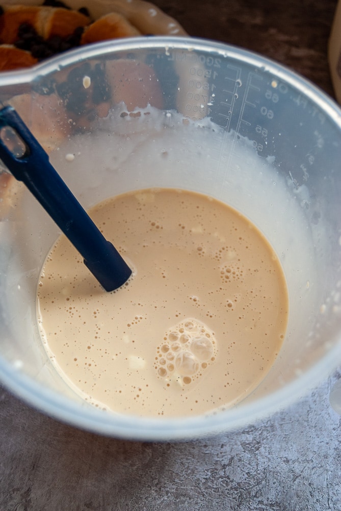 A plastic jug of cream, eggs, milk, vanilla and baileys for making a custard.