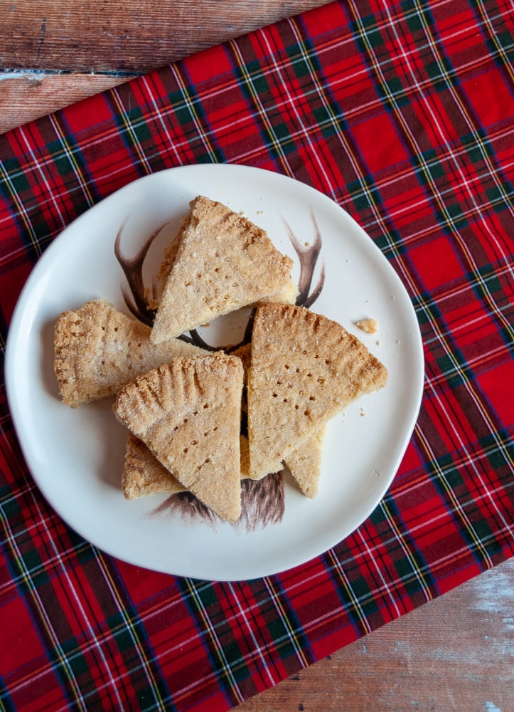 A plate of Shortbread on a white Plate and tartan tablecloth 