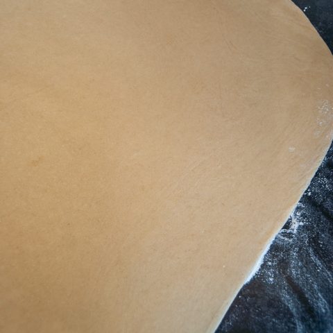 sweet dough rolled out into a rectangle on a worktop