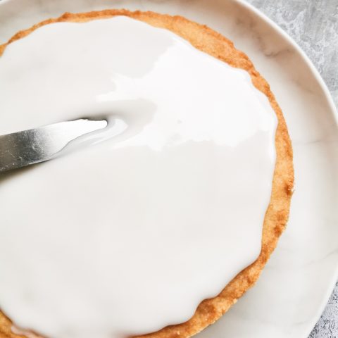 A large shortbread cookie spread with a white glaze icing