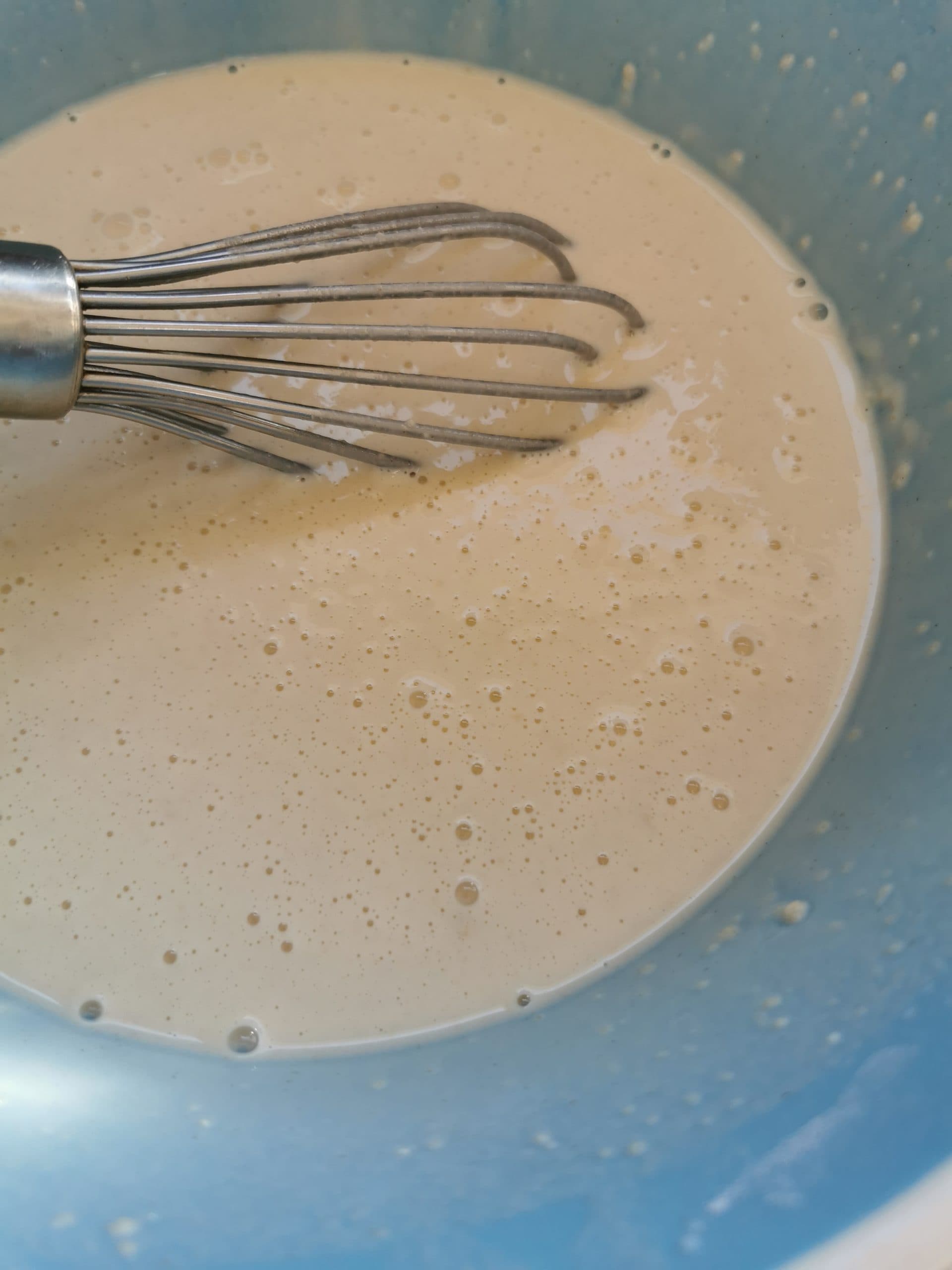 A close up picture of a bowl of pancake batter