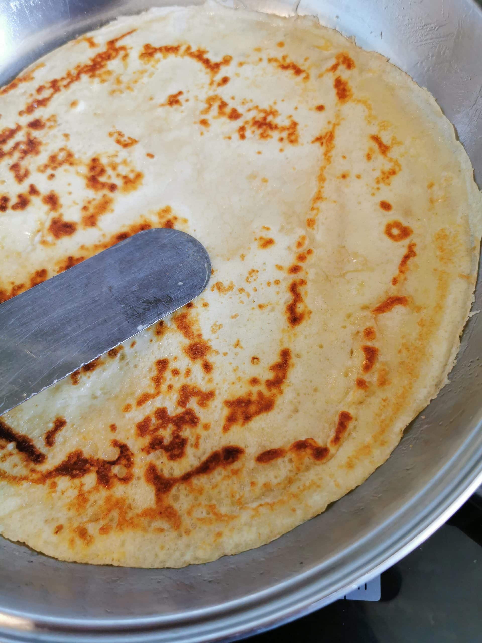 A freshly made pancake in a pan