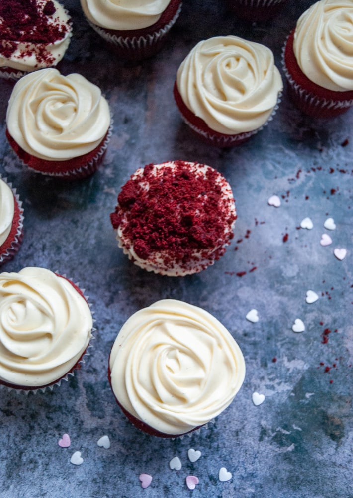 Red Velvet Cupcakes with cream cheese icing on a grey background