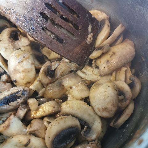 Onions and mushrooms cooking in a pan