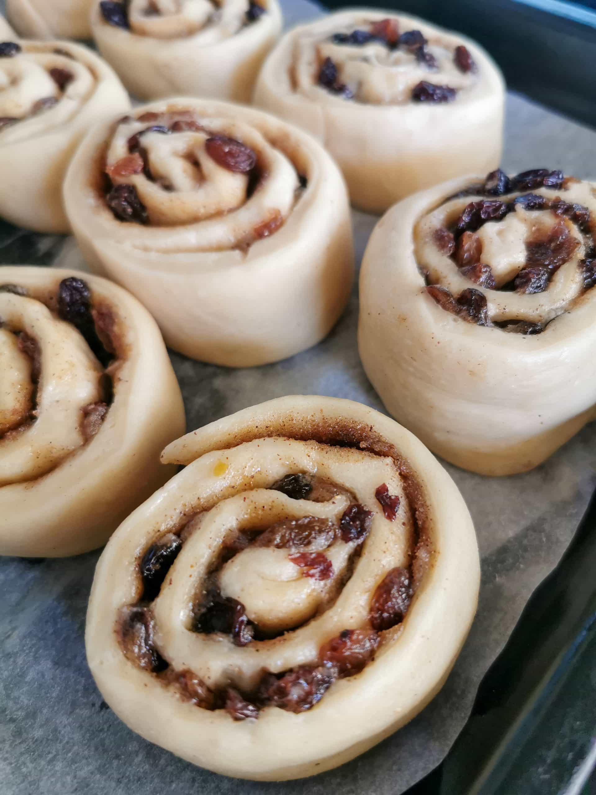 Unbaked Chelsea buns on a baking tray