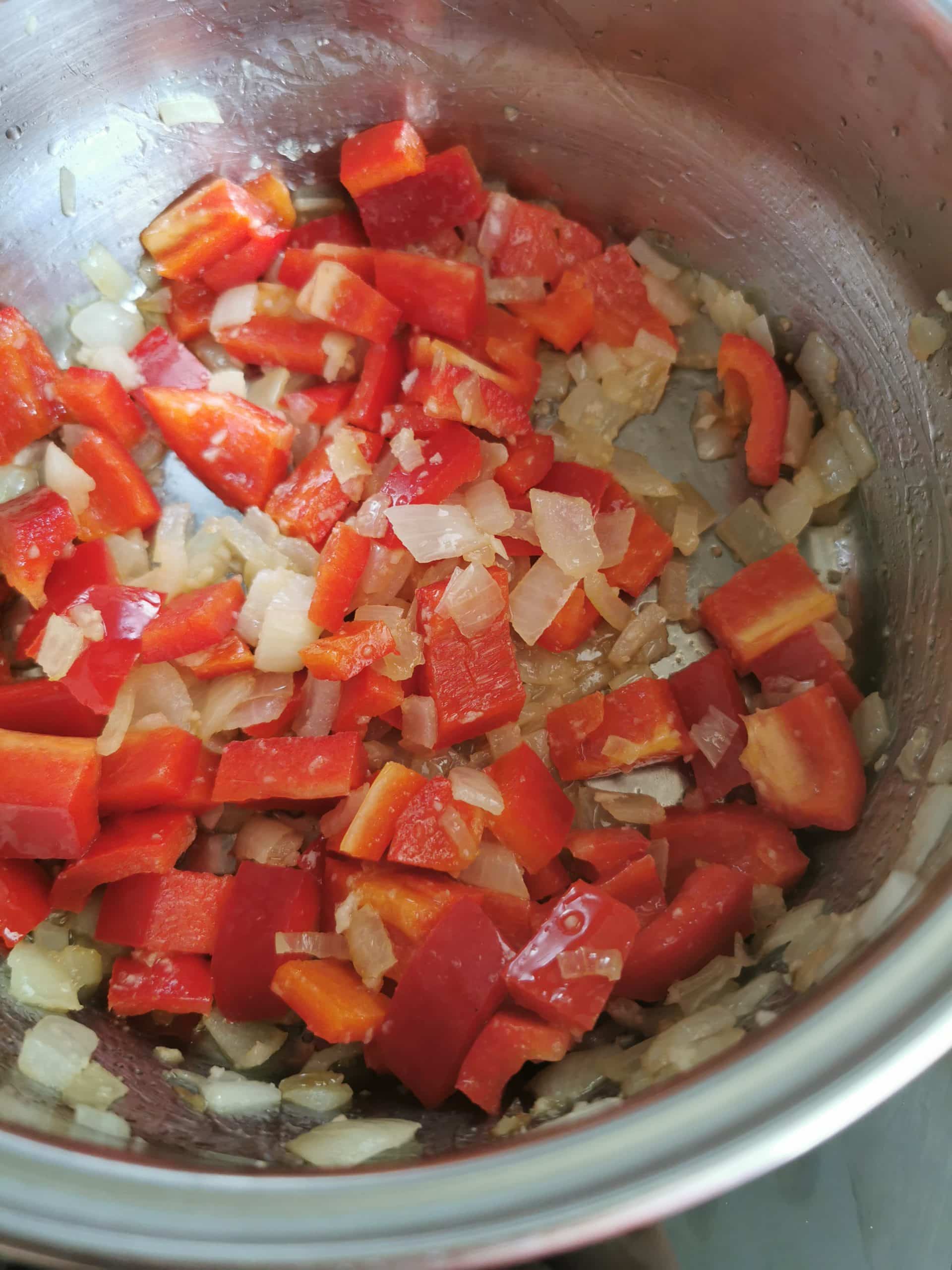 Diced onion, garlic and red peppers in a saucepan