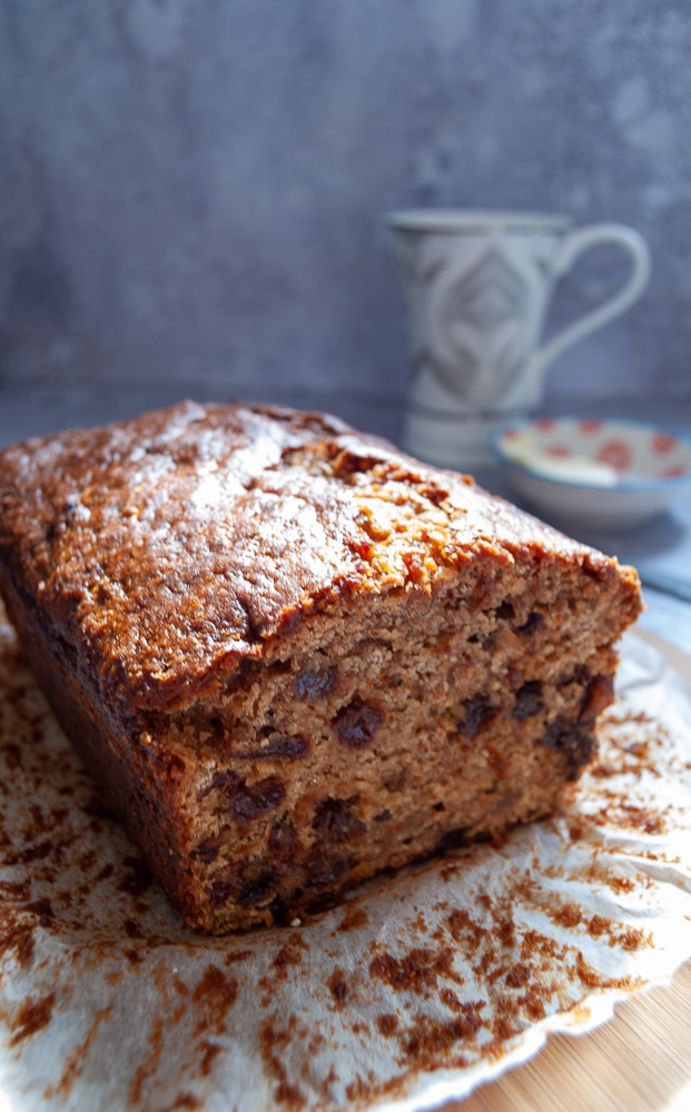 A sliced fruit loaf on a wooden board