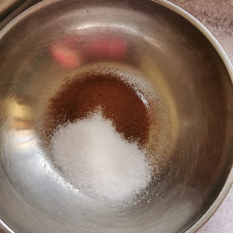 Instant coffee and sugar in a silver bowl.