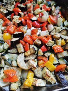 A tray of roasted peppers, aubergine, onion and tomatoes
