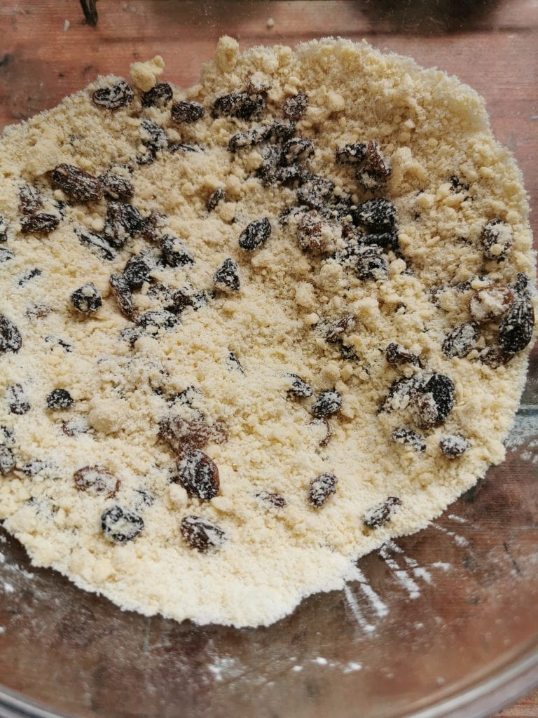 Flour, butter and dried fruit in a large bowl