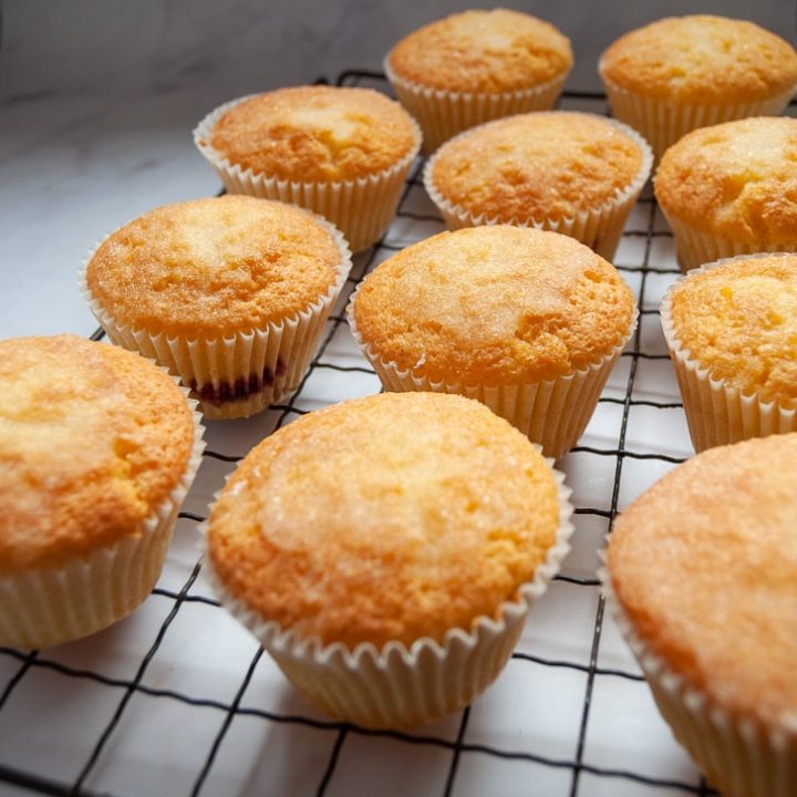 Lemon cupcakes on a black wire rack