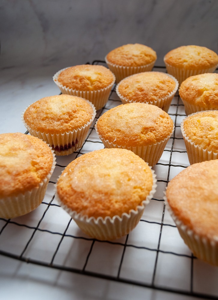 Lemon cupcakes on a black wire rack