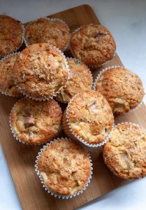 A batch of rhubarb muffins on a wooden board