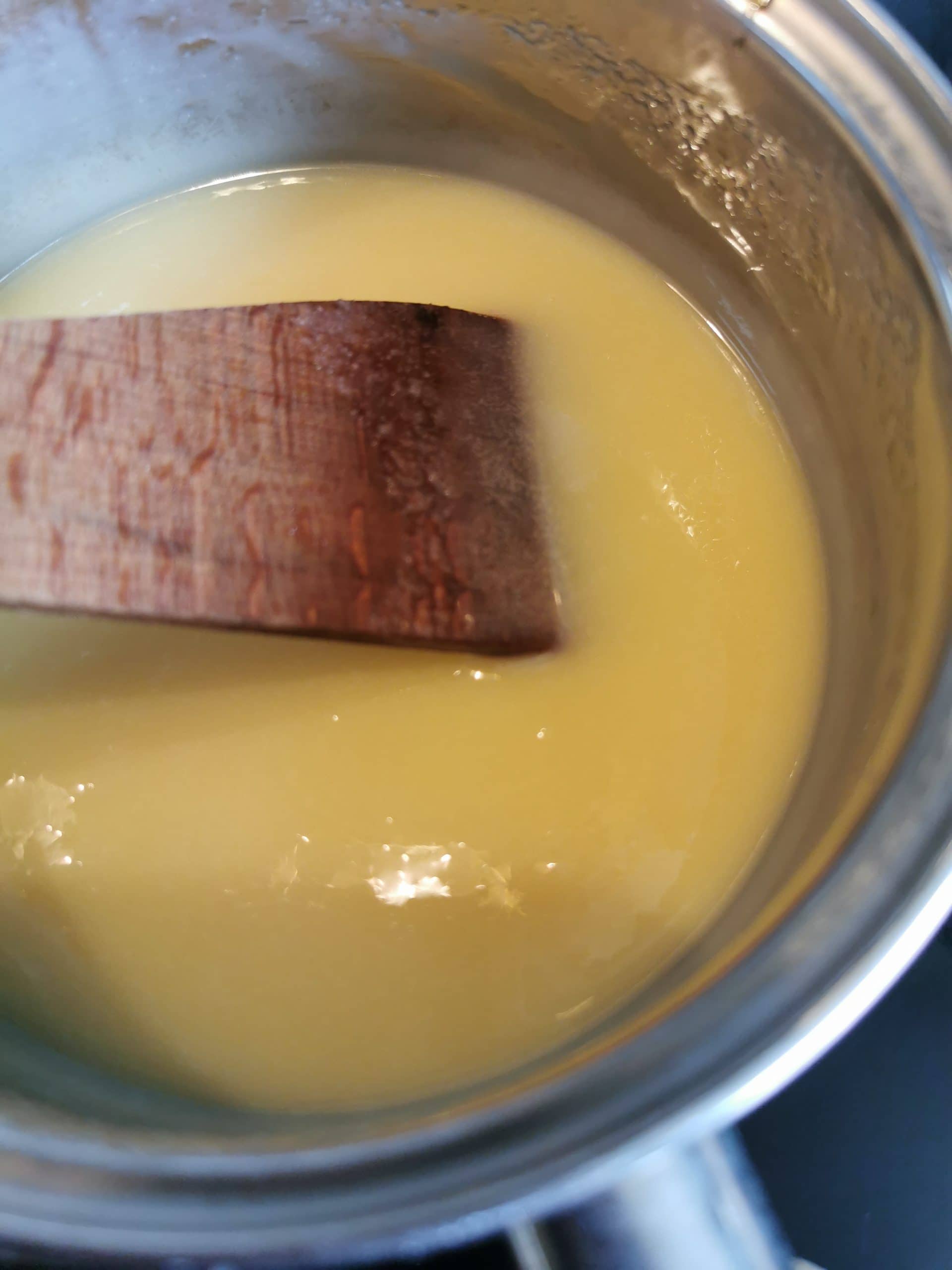 A pan of melted condensed milk, sugar and butter for making caramel
