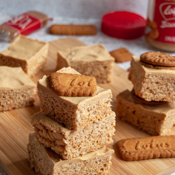 3 pieces of biscoff rice krispie squares stacked on top of each other topped with a Biscoff cookie