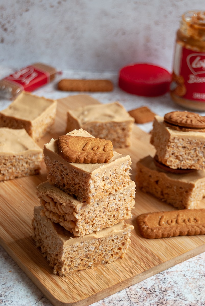 3 pieces of biscoff rice krispie squares stacked on top of each other topped with a Biscoff cookie