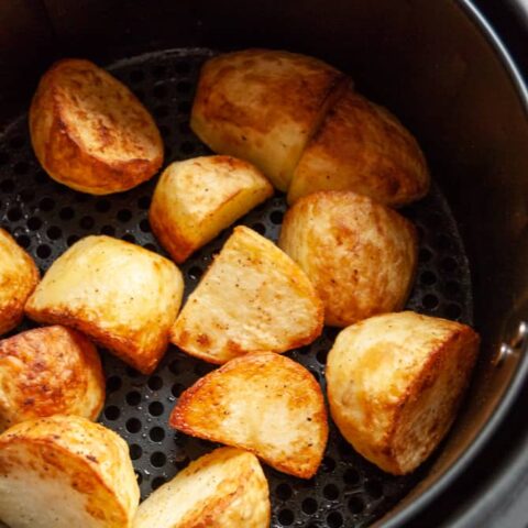 roast potatoes in a black and silver air fryer