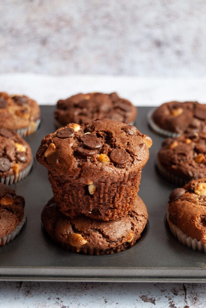 a close up picture of a pan of chocolate chip muffins