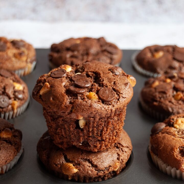 a close up picture of a pan of chocolate chip muffins