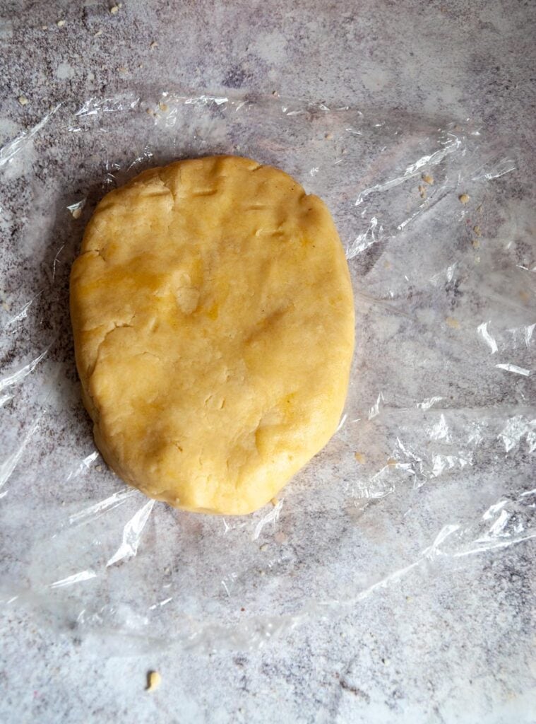  unbaked pie dough on a piece of plastic wrap