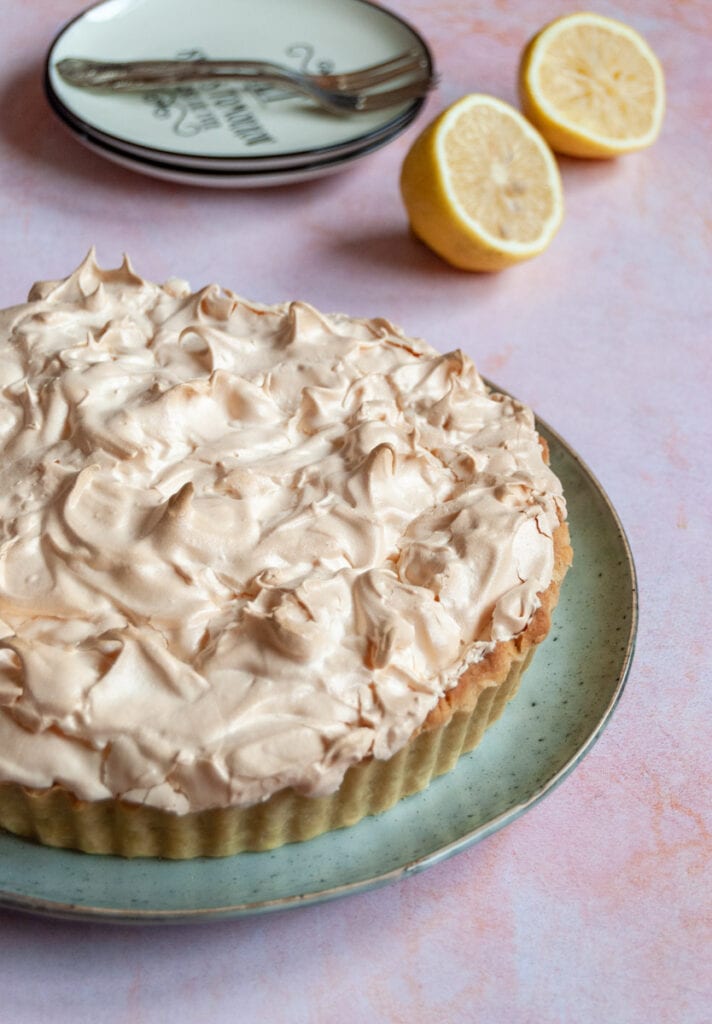 a lemon meringue pie on a green speckled plate