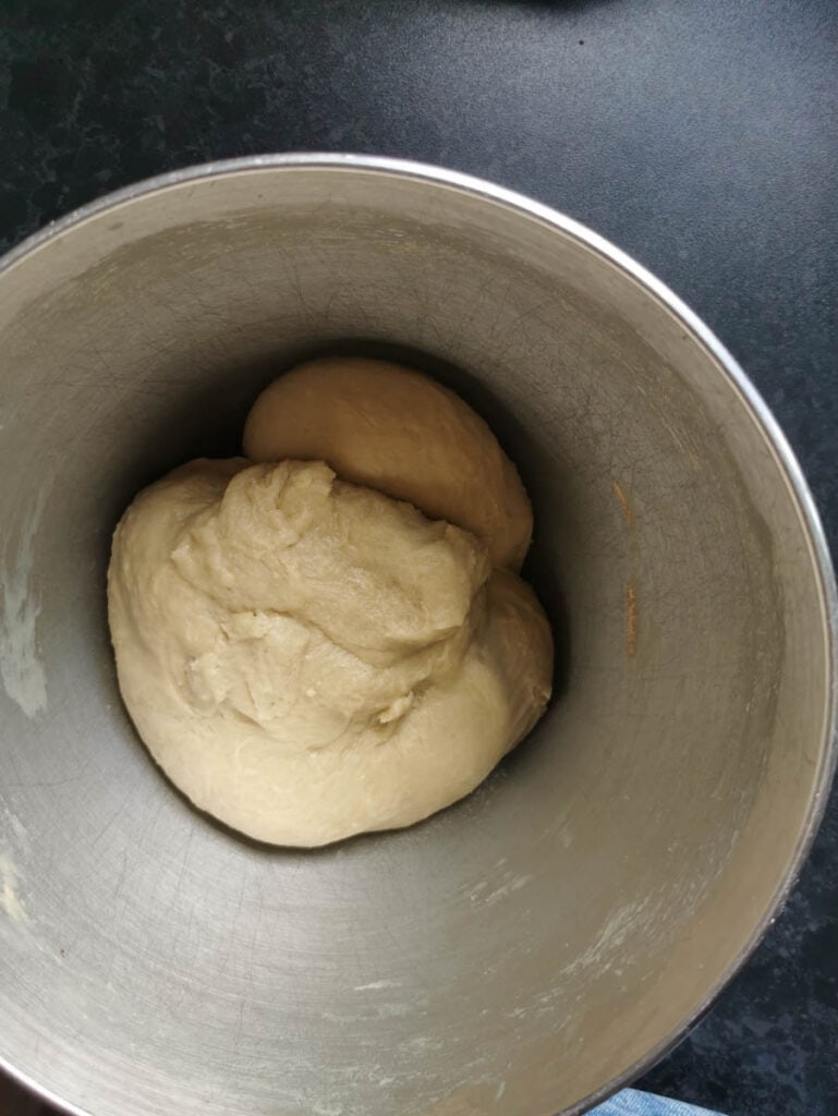 sweet bread dough in a large silver bowl