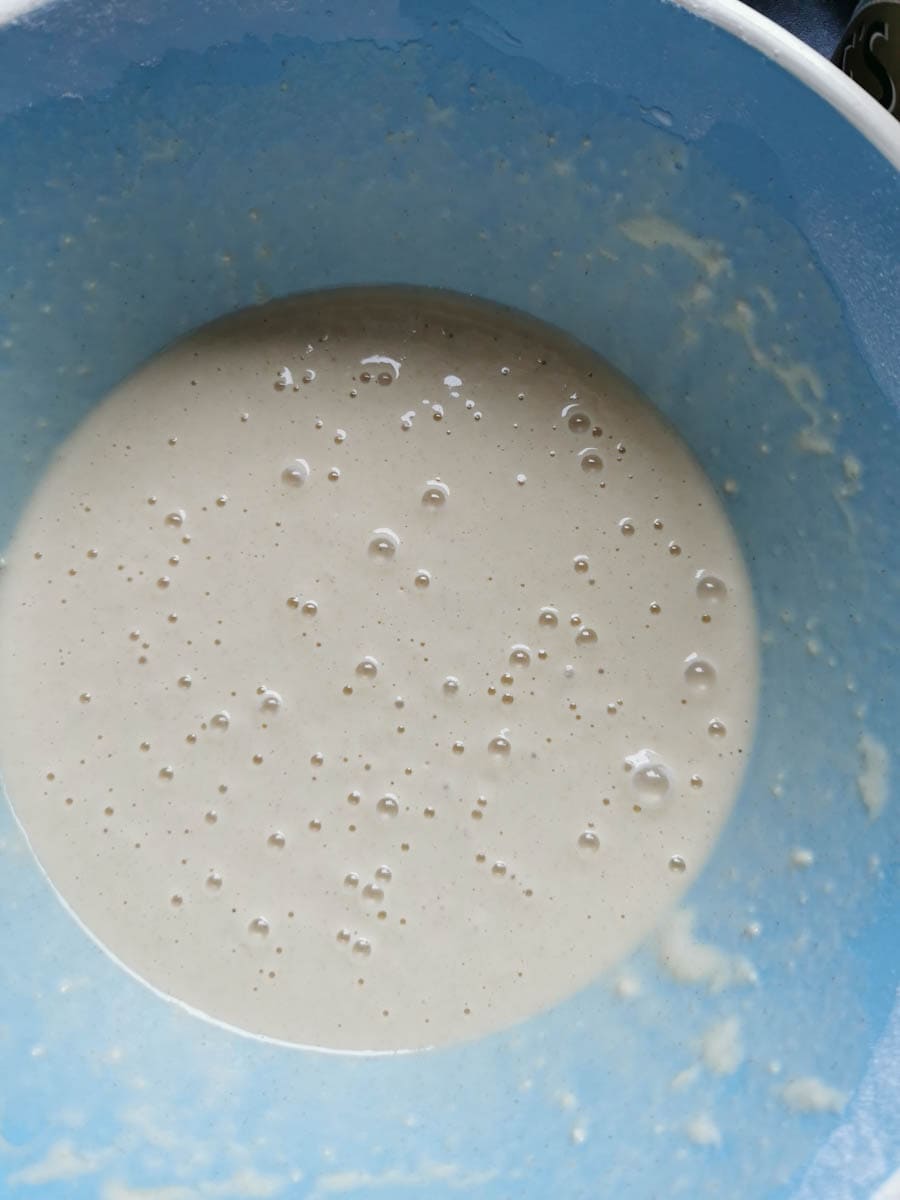A blue bowl of pancake batter.