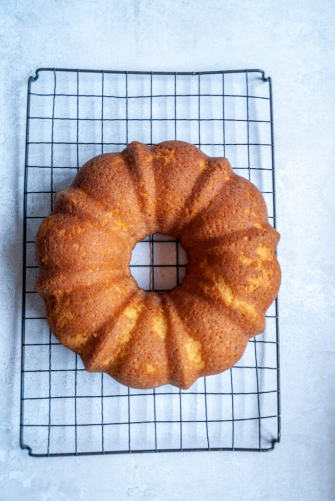 a lemon bundt cake on a wire cooling rack