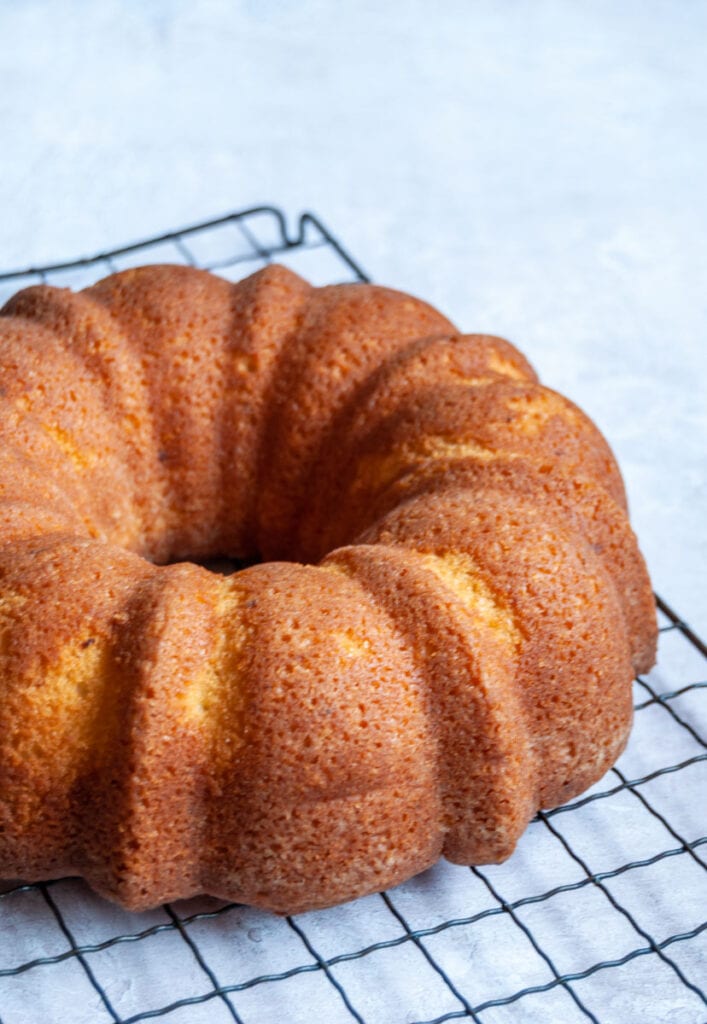 a lemon bundt cake on a black wire rack.