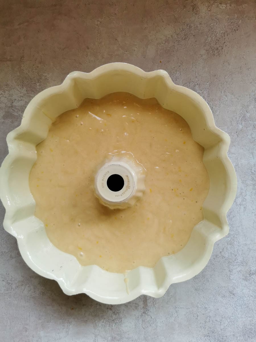 a cream coloured bundt tin with cake batter