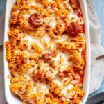 a chicken and chorizo pasta bake in a white gratin dish.