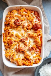 a chicken and chorizo pasta bake in a white gratin dish.