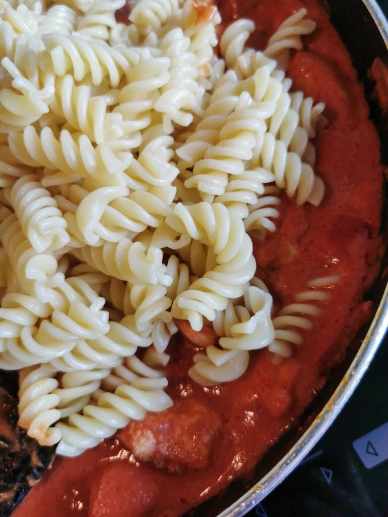 Pasta twists and a tomato sauce in a frying pan