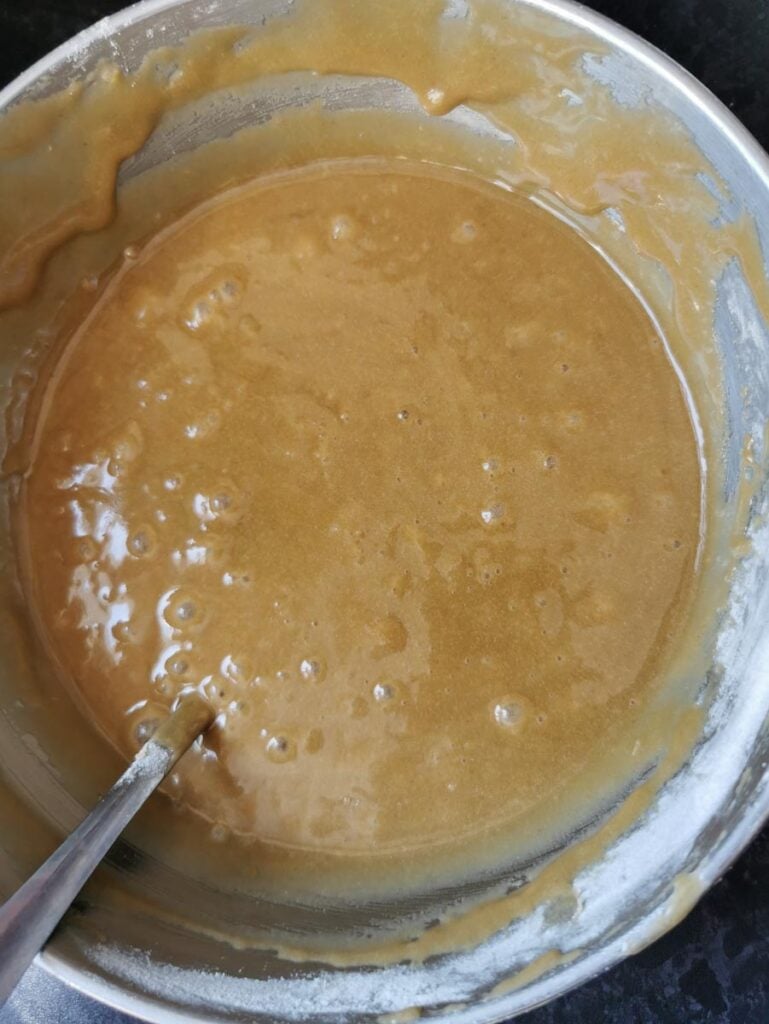 blondie batter in a silver bowl with a spoon