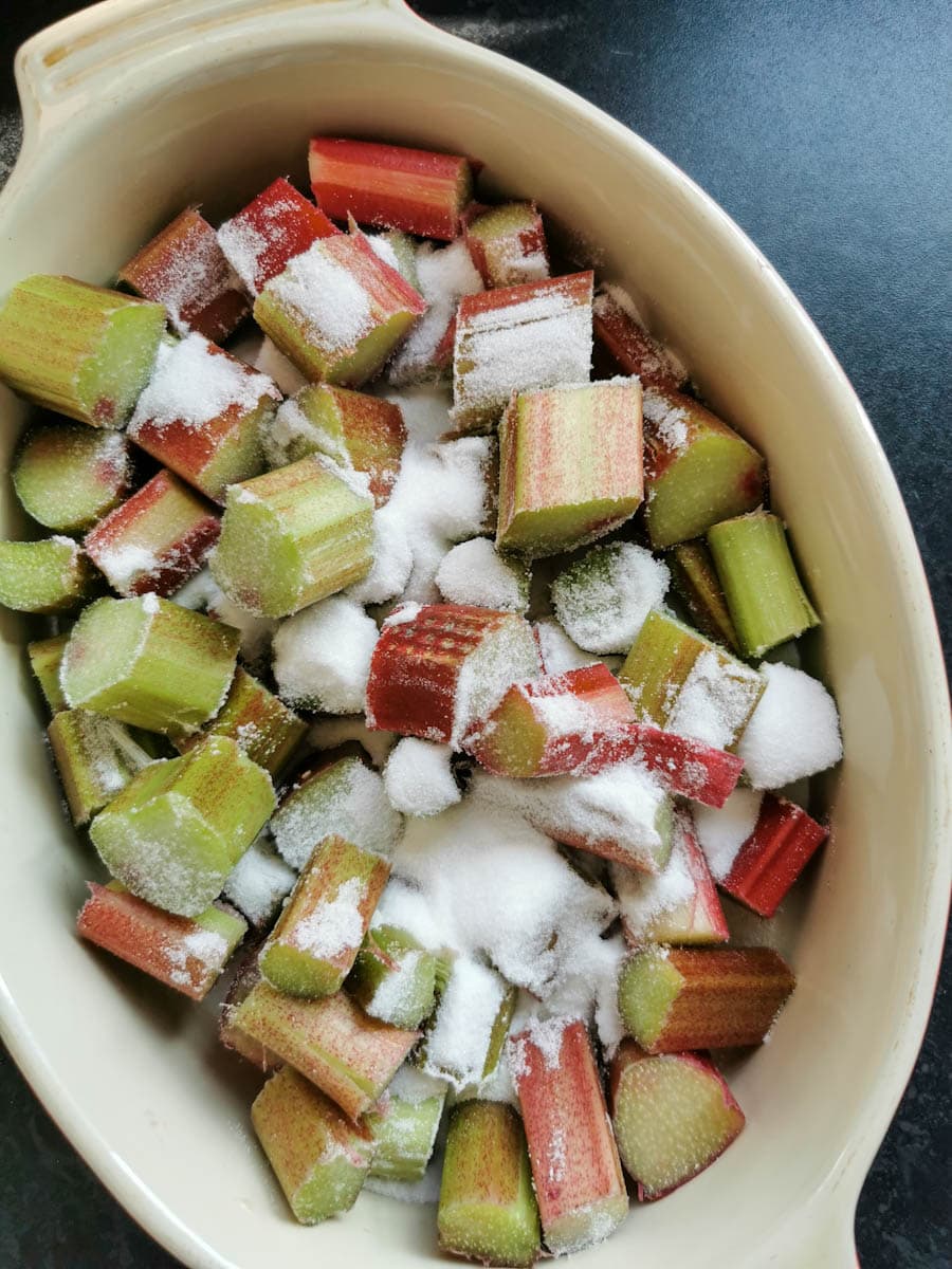 a dish of chopped rhubarb sprinkled with white sugar.