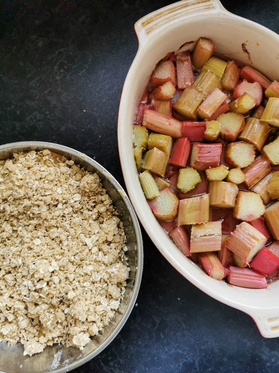 an oval dish of roasted rhubarb and a bowl of crumble topping