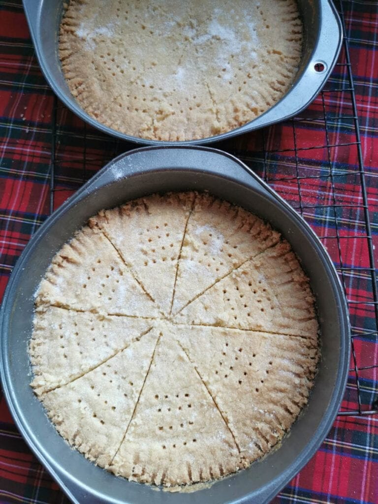 two silver tins of shortbread sprinkled with sugar.