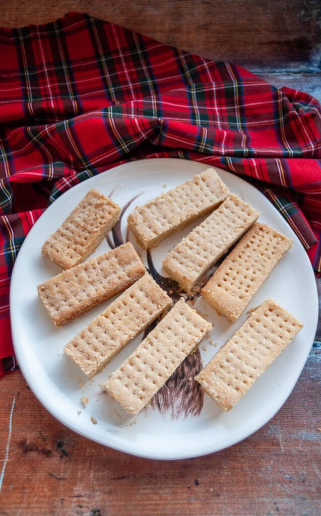 a plate of shortbread fingers and a tartan tablecloth.