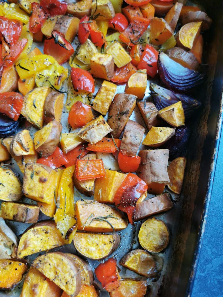 roasted sweet potato chunks, onion, garlic, red pepper and herbs in a roasting tin.