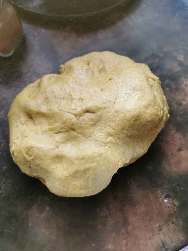 pumpkin bread dough in a glass mixing bowl