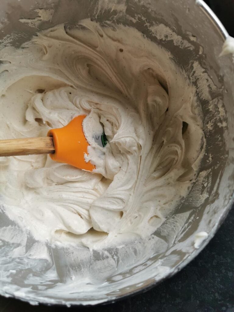 A silver bowl of cream cheese frosting