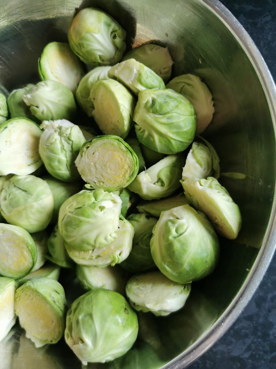 a silver bowl of brussels sprouts