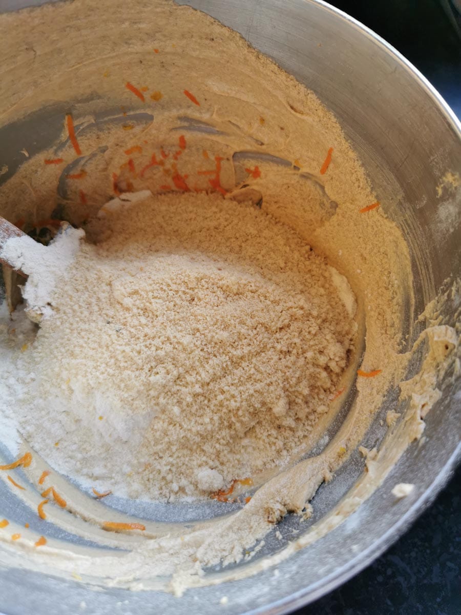 a silver bowl of creamed butter, sugar, orange zest and ground almonds.