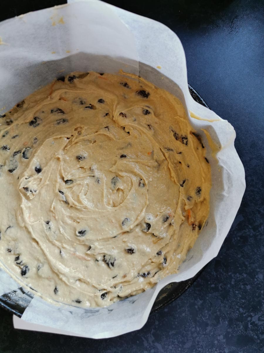 fruit cake batter in a lined round cake tin.